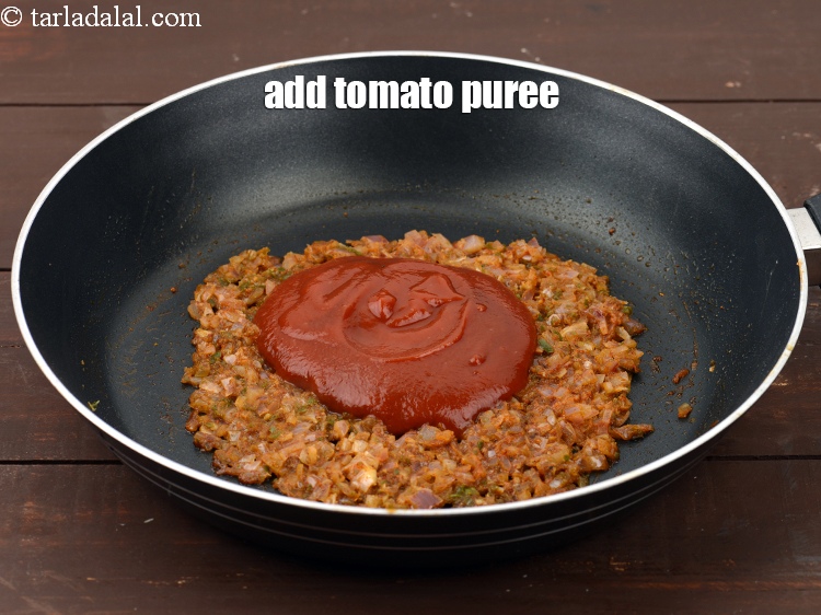 Step 26 – Add 1/3 cup <a href="https://www.tarladalal.com/glossary-tomato-puree-tamatar-ki-puree-487i">tomato puree</a>.