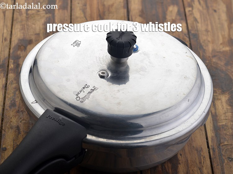 Step 8 – Close the lid and pressure cook the rajmas for 3&nbsp;whistles or on a medium flame.