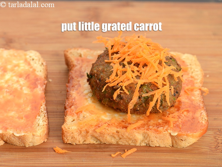 Step 25 – Put little <a href="https://www.tarladalal.com/glossary-grated-carrot-816i">grated carrot</a>.
