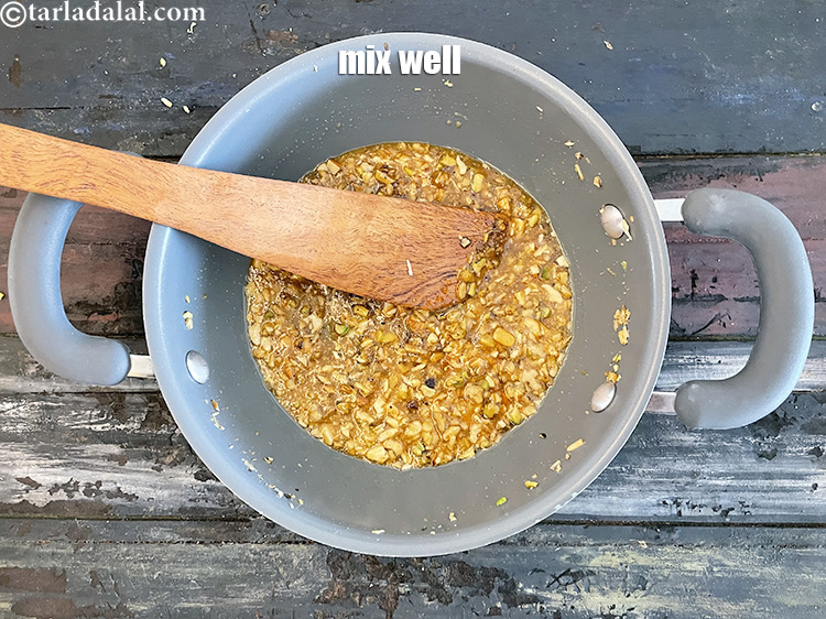 Step 33 – Mix well so that the elaichi powder flavour gives the ladoo a lovely taste.