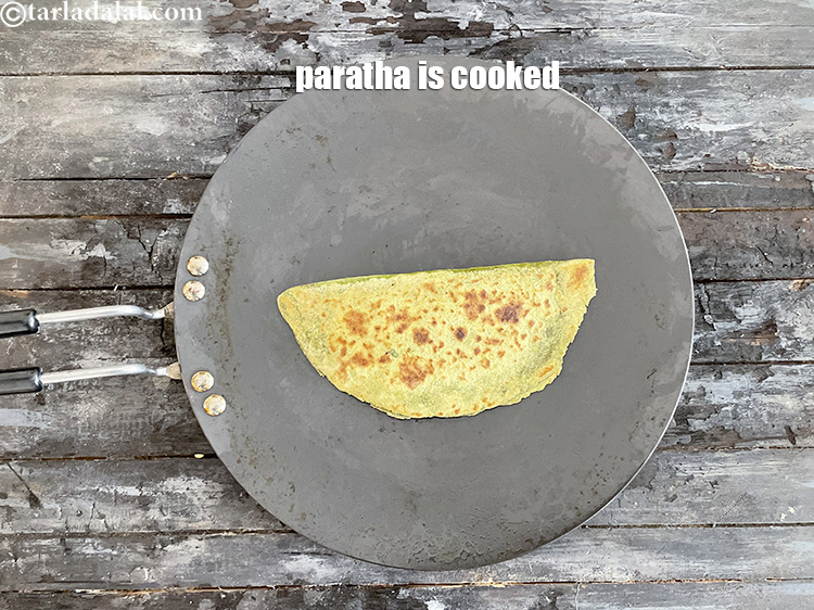 Step 51 – Flip over and cook the other side. Keep flipping and cooking the paratha till golden …