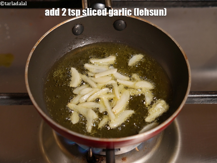Step 31 – Add 2 tsp&nbsp;<a href="https://www.tarladalal.com/glossary-sliced-garlic-773i">sliced garlic (lehsun)</a>.
