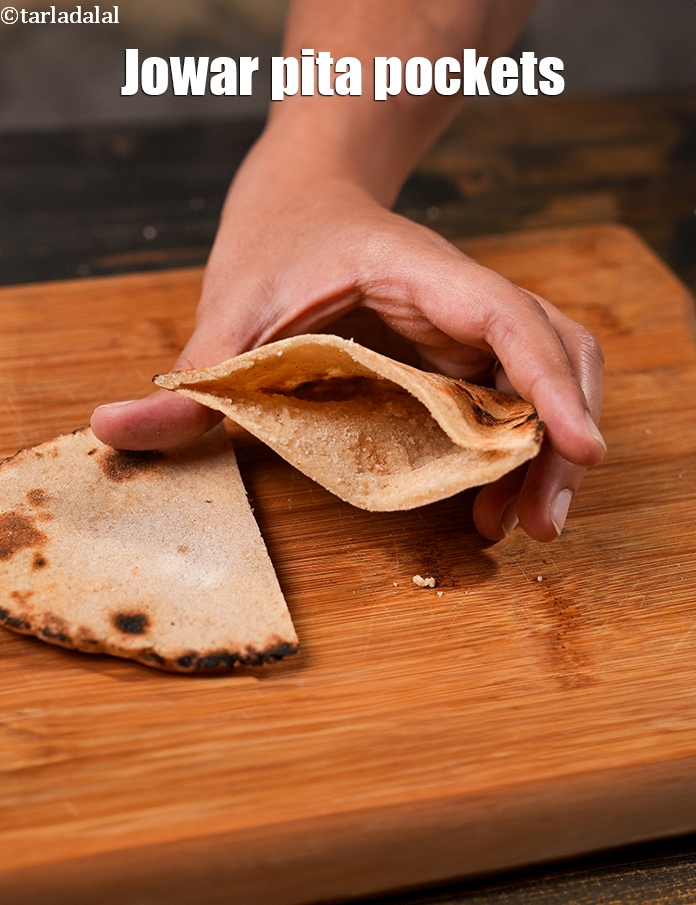 Step 25 – Cut each&nbsp;<strong>jowar pita bread</strong>&nbsp;into 2 halves horizontally and use as required. This is called <strong>Jowar …