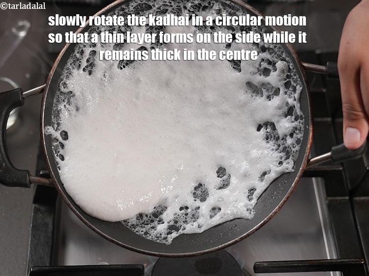 Step 30 – Slowly rotate the kadhai in a circular motion so that a thin layer forms on …