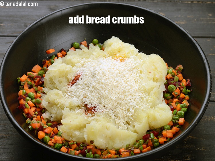 Step 26 – Add &frac14; cup <a href="https://www.tarladalal.com/glossary-bread-crumbs-breadcrumbs-222i">bread crumbs</a>.