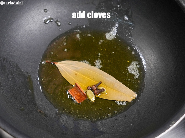 Step 25 – Add 3 <a href="https://www.tarladalal.com/glossary-cloves-laung-lavang-322i">cloves (laung / lavang)</a>.
