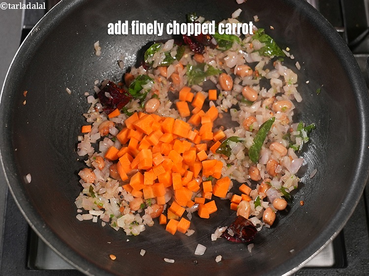Step 25 – Add &frac14; cup finely <a href="https://www.tarladalal.com/glossary-chopped-carrot-798i">chopped carrot</a>.&nbsp;