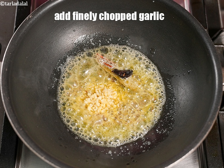 Step 25 – Add 1 tbsp finely <a href="https://www.tarladalal.com/glossary-chopped-garlic-790i">chopped garlic (lehsun)</a>.