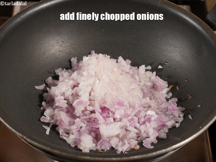 Step 25 – Add 1 cup finely <a href="https://www.tarladalal.com/glossary-chopped-onions-722i">chopped onions</a>.