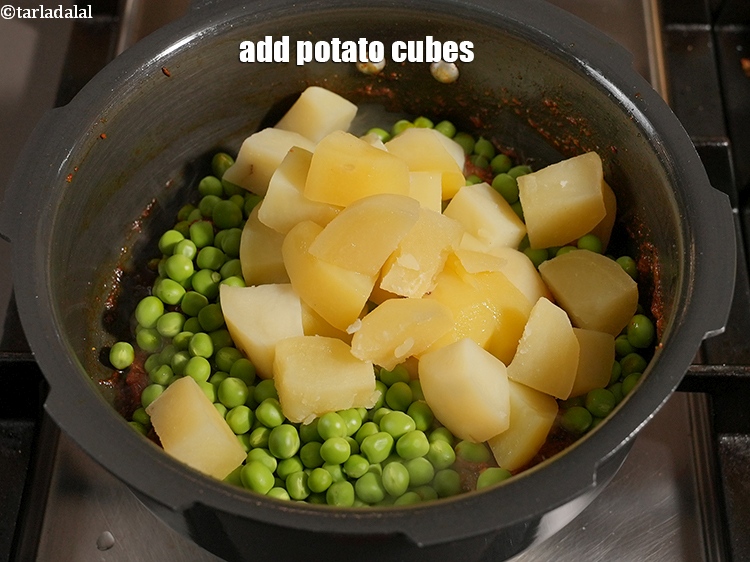 Step 25 – Add 1&frac12; cups <a href="https://www.tarladalal.com/glossary-potato-cubes-725i">potato cubes</a>.