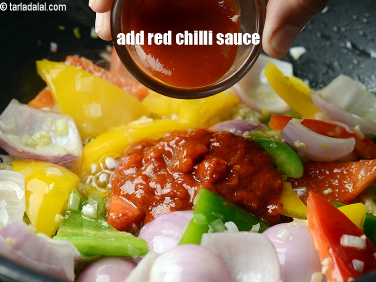 Step 26 – Add 2 tsp <a href="https://www.tarladalal.com/glossary-red-chilli-sauce-lal-chilli-sauce-810i">red chilli sauce</a>.