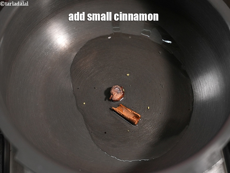 Step 25 – Add 1 small <a href="https://www.tarladalal.com/glossary-cinnamon-dalchini-346i">cinnamon (dalchini)</a>.&nbsp;