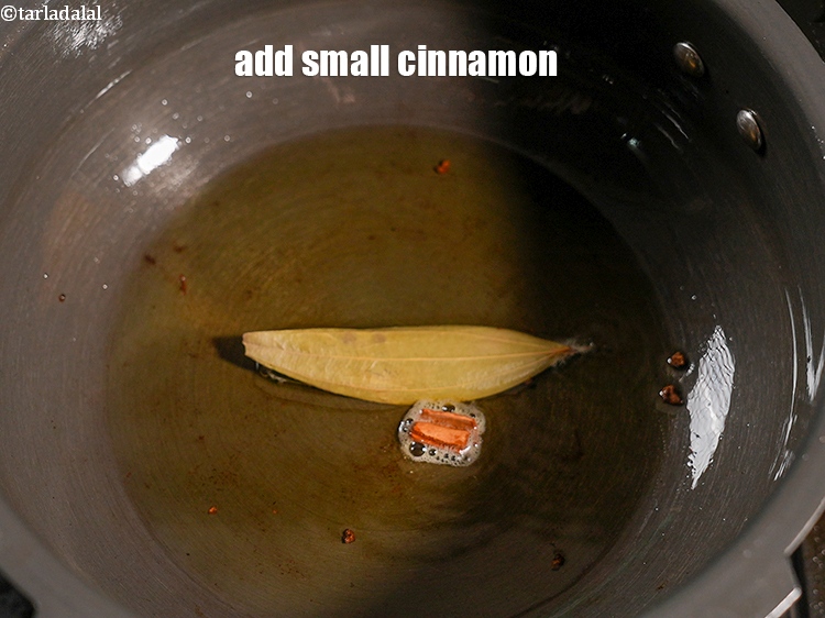 Step 25 – Add 1 small <a href="https://www.tarladalal.com/glossary-cinnamon-dalchini-346i">cinnamon (dalchini)</a>.