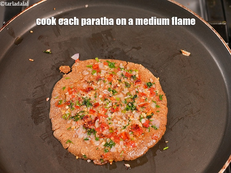 Step 26 – Cook each paratha on a medium flame.