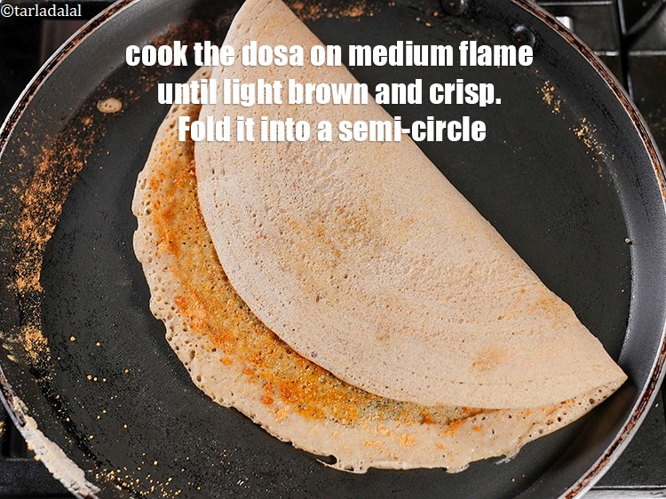 Step 26 – Cook the dosa on medium flame until light brown and crisp. Fold it into a …