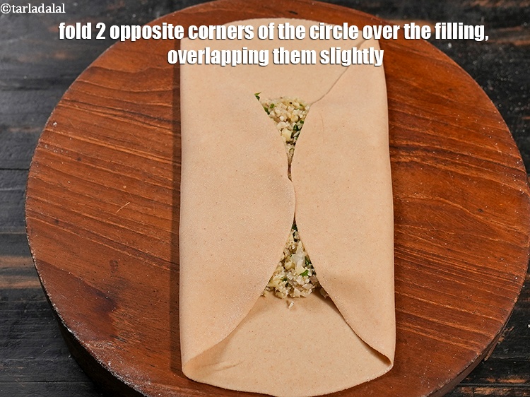 Step 25 – Fold 2 opposite corners of the circle over the filling, overlapping them slightly.