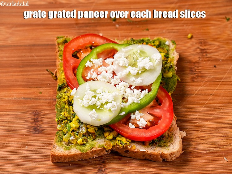 Step 25 – Grate 1 tsp of <a href="https://www.tarladalal.com/glossary-grated-panee-1003i">grated paneer (cottage cheese)</a> over each bread slices.&nbsp;
