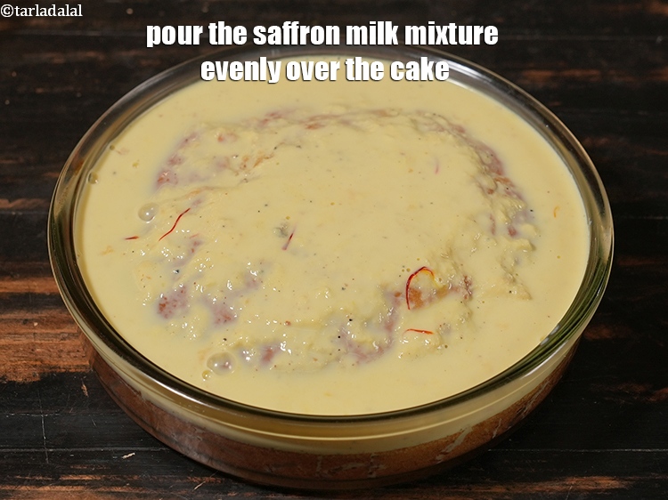 Step 25 – Pour the saffron milk mixture evenly over the cake.
