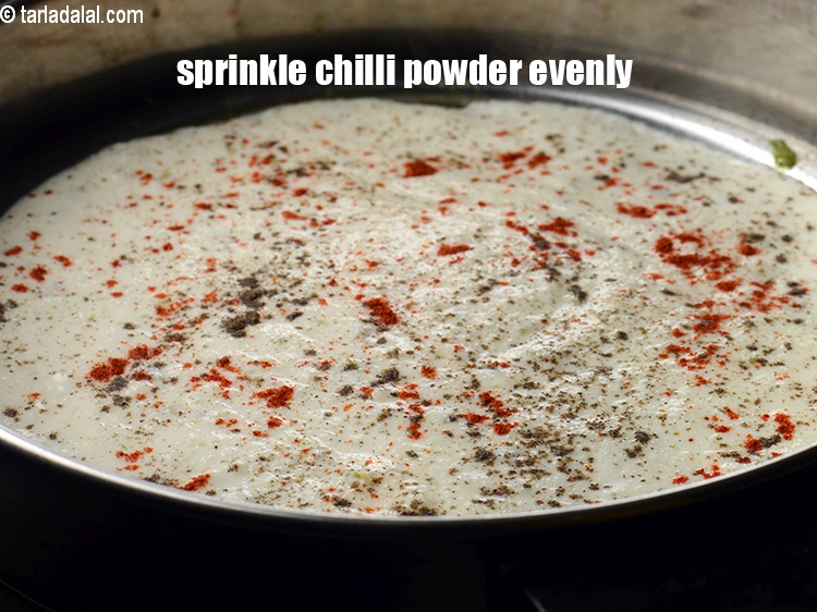 Step 26 – Sprinkle little <a href="https://www.tarladalal.com/glossary-chilli-powder-red-chilli-powder-339i">chilli powder</a> evenly over the dhokla.&nbsp;