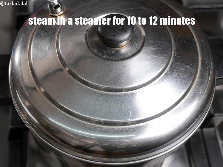 Step 25 – Steam in a steamer for 10 to 12 minutes or till the idlis are cooked.