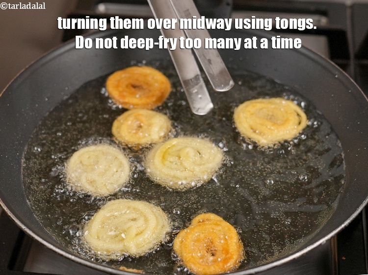 Step 25 – Turning them over midway using tongs. Do not deep-fry too many at a time.