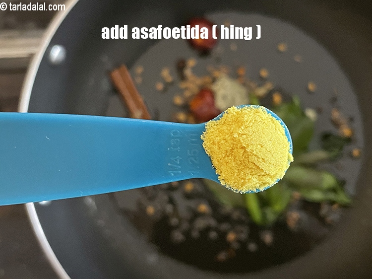 Step 25 – <p>Add 1/4 tsp <a href="https://www.tarladalal.com/glossary-asafoetida-hing-113i"><strong>asafoetida (hing)</strong></a><strong>.</strong></p>