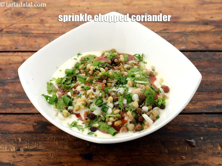 Step 57 – Finally sprinkle 1 tbsp <a href="https://www.tarladalal.com/glossary-coriander-dhania-kothmir-369i#ing_783" target="_blank">coriander</a> evenly over it.