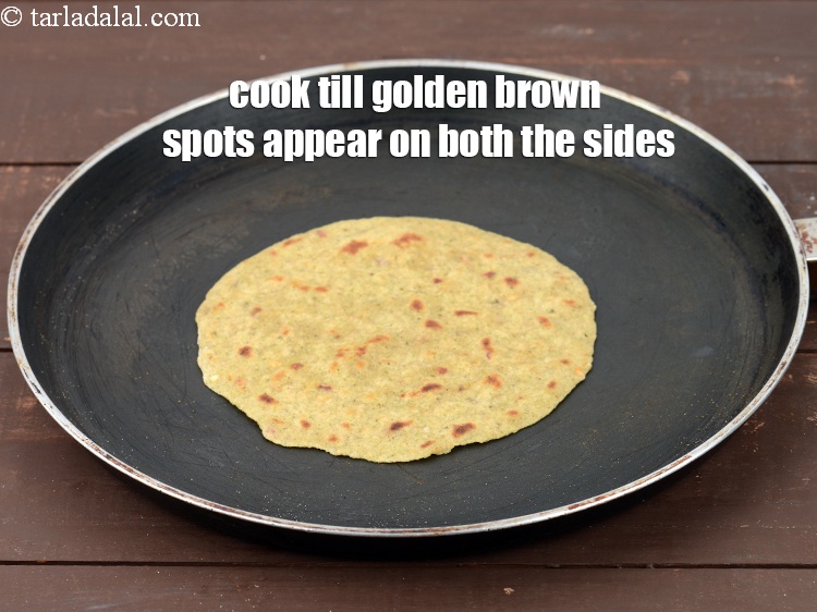 Step 25 – Cook the paratha till golden brown spots appear on both the sides.