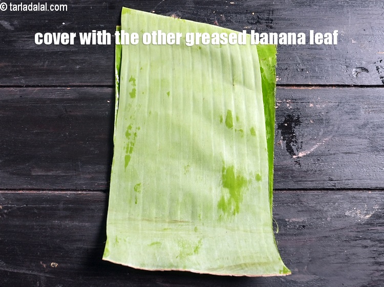 Step 34 – Cover with the other greased banana leaf with the greased side facing downwards.