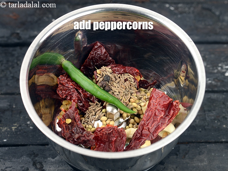 Step 26 – Add 4 <a href="https://www.tarladalal.com/glossary-peppercorns-584i">peppercorns (kalimirch)</a>.