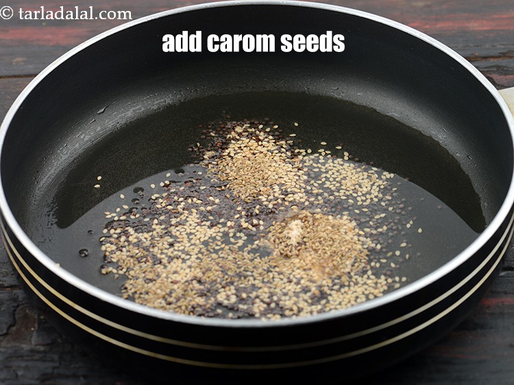 Step 25 – Add 1/2 tsp&nbsp;<a href="https://www.tarladalal.com/glossary-carom-seeds-ajwain-thymol-seeds-bishops-weed-266i">carom seeds (ajwain)</a>.&nbsp;