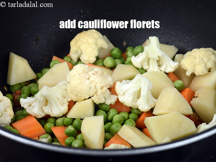 Step 26 – Add &frac12; cup <a href="https://www.tarladalal.com/glossary-cauliflower-florets-753i">cauliflower florets</a>.
