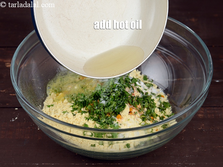 Step 11 – Add 1 tbsp hot&nbsp;<a href="https://www.tarladalal.com/glossary-oil-671i">oil</a>. This helps to make the pakora crispy.