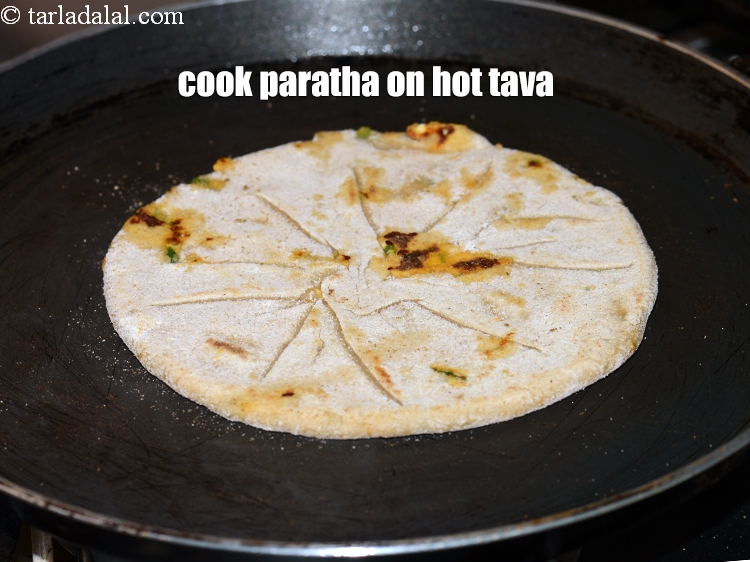 Step 26 – Cook the paratha on a hot tava (griddle).