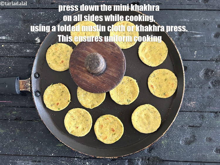Step 34 – Press down the khakhra on all sides while cooking,&nbsp;using a folded muslin cloth or khakhra …