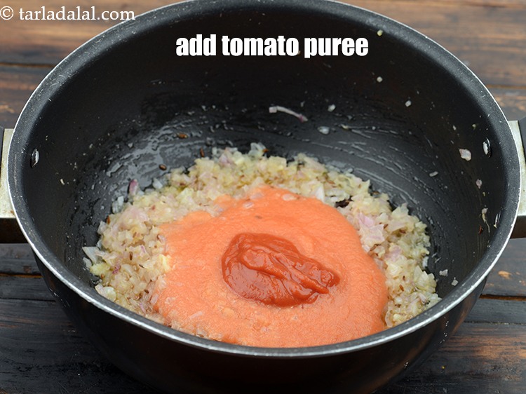 Step 26 – Add 1/4 cup&nbsp;<a href="https://www.tarladalal.com/glossary-tomato-puree-tamatar-ki-puree-487i">tomato puree</a>. It gives nice colour and tangy taste to the gravy.
