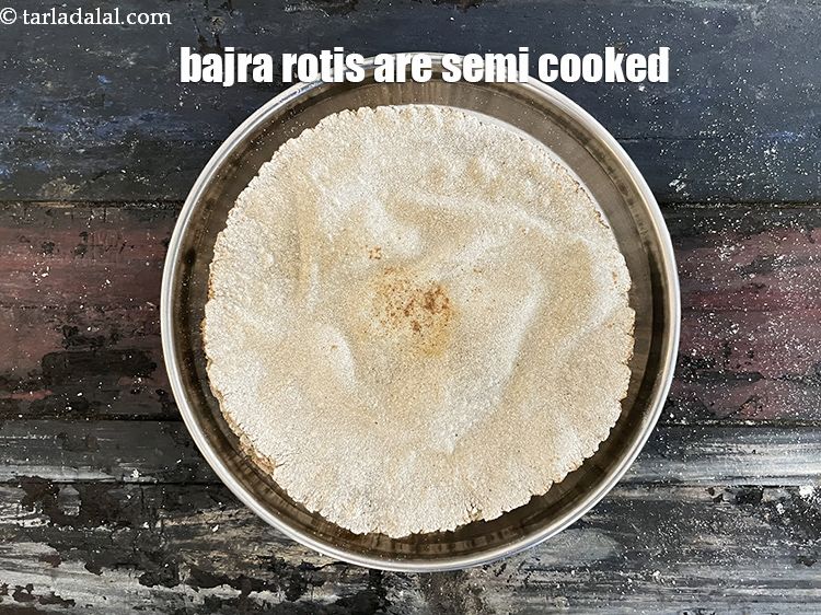 Step 28 – Your bajra rotis are semi cooked and ready. Place all 8 rotis in a plate. …