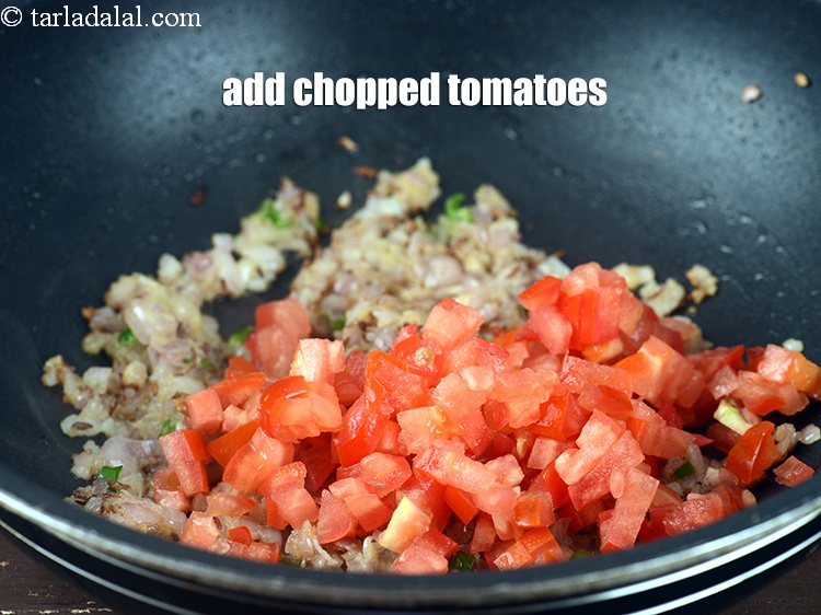 Step 25 – Add &frac12; cup <a href="https://www.tarladalal.com/glossary-chopped-tomatoes-779i">chopped tomatoes</a>.