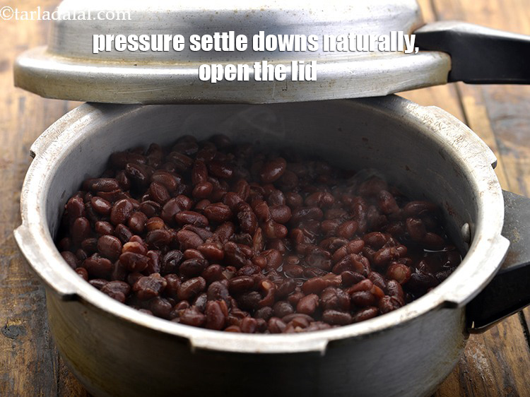 Step 9 – When the pressure settle downs naturally, open the lid and mix once.Check if the rajma …