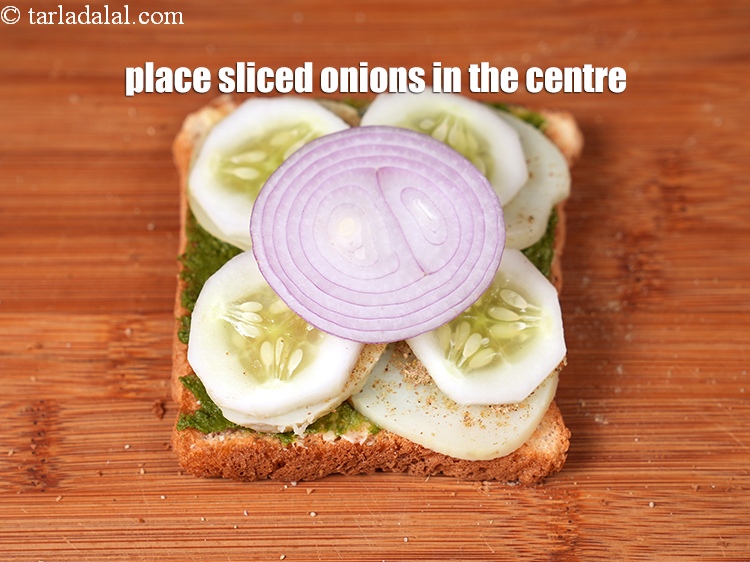 Step 27 – Place 1 <a href="https://www.tarladalal.com/glossary-sliced-onions-745i">sliced onions</a> in the centre.