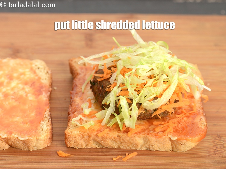 Step 26 – Put little <a href="https://www.tarladalal.com/glossary-shredded-lettuce-856i">shredded lettuce</a> evenly over it.