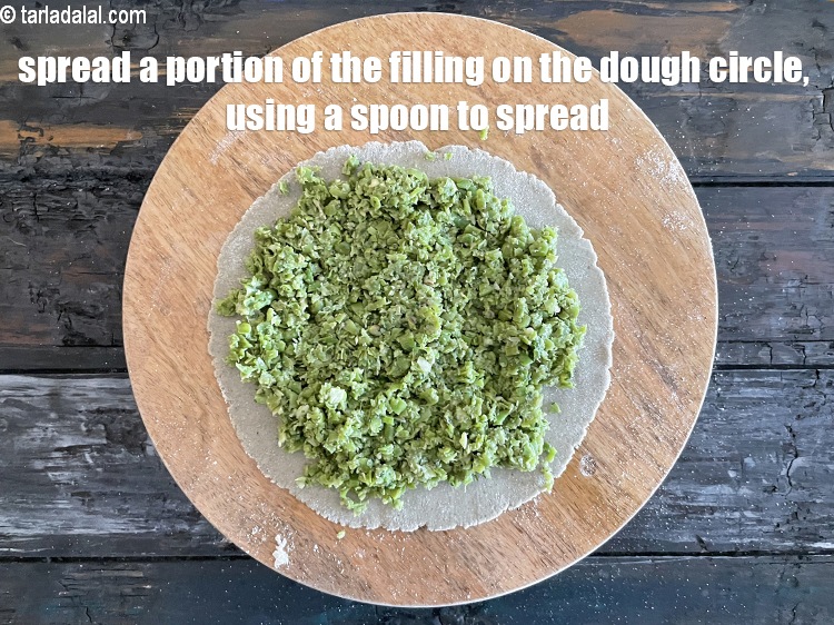 Step 26 – Place a dough circle on a flat, dry surface and spread a portion of the …