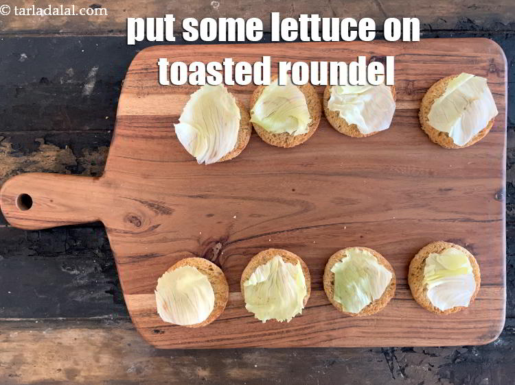 Step 24 – Place &nbsp;toasted bread roundel on a clean, flat surface, put a small piece of lettuce …