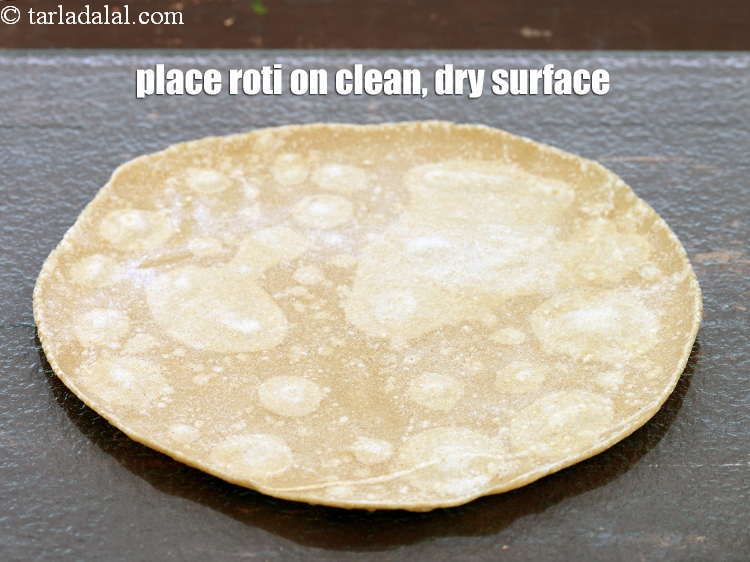 Step 26 – Place a <a href="https://www.tarladalal.com/rotis-32622r">roti</a>&nbsp;on a clean, dry surface.