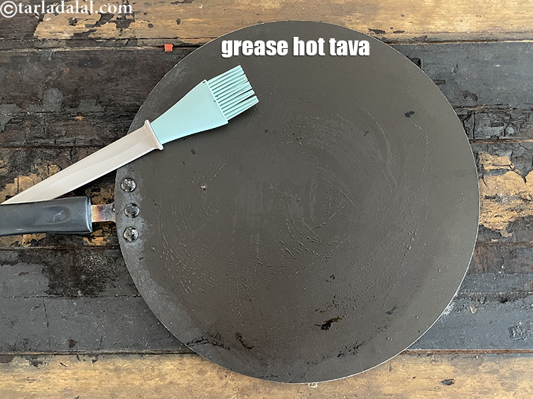 Step 42 – <meta charset="UTF-8" />Heat a non-stick tava (griddle) and lightly grease it &frac14; tsp of oil.