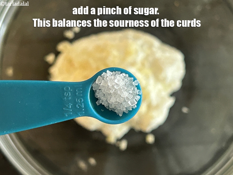 Step 27 – Add&nbsp;<meta charset="UTF-8" />a pinch of&nbsp;<a href="glossary-sugar-chini-shakkar-278i">sugar</a>. This balances the sourness of the curds.&nbsp;
