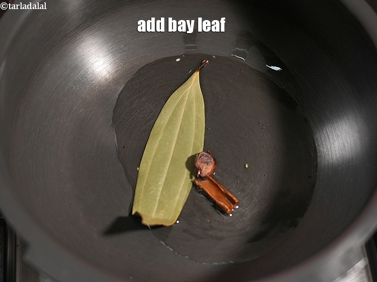 Step 26 – Add 1 <a href="https://www.tarladalal.com/glossary-bay-leaf-tejpatta-bay-leaves-189i">bay leaf (tejpatta)</a>.