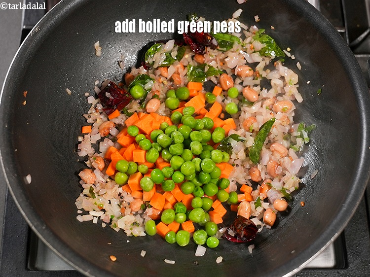 Step 26 – Add &frac14; cup <a href="https://www.tarladalal.com/glossary-boiled-green-peas-1078i">boiled green peas</a>.