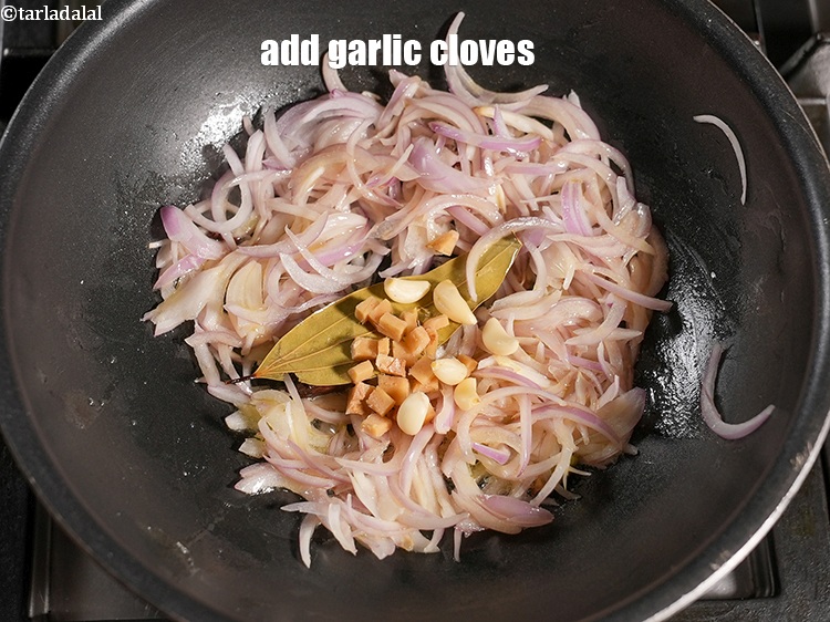 Step 27 – Add 8 to 10 <a href="https://www.tarladalal.com/glossary-garlic-cloves-1857i">garlic (lehsun) cloves</a>.