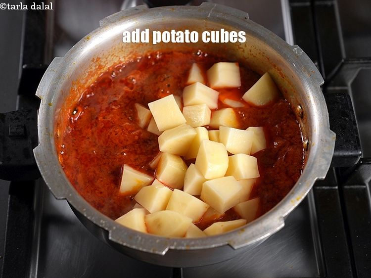 Step 26 – Add 1&frac12; cups <a href="https://www.tarladalal.com/glossary-potato-cubes-725i">potato cubes</a>.